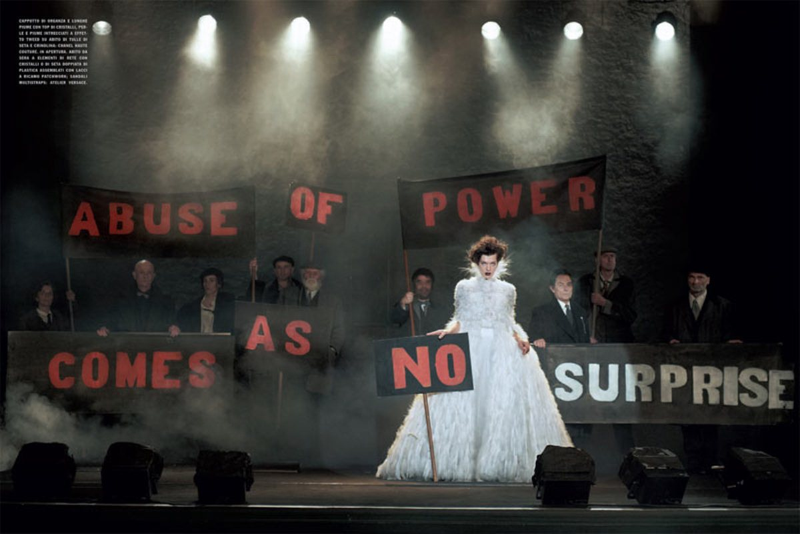 Illustration for article titled Incredibly Lovely: Milla Jovovich marches with Jenny Holtzer slogans in a dystopian future